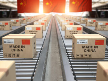 Made in China. Cardboard boxes with text made in China and chinese flag on the roller conveyor. 3d illustration