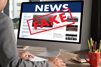 Fake news Young man using laptop Daily News Journal Update  Fake news